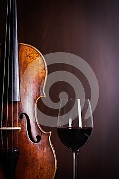 Violin waist detail with glass of wine