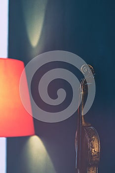 Violin on the wall by the red lamp