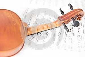 Violin on white background from an unfocused sheet music.