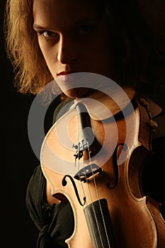 Violinist dark portrait on black
