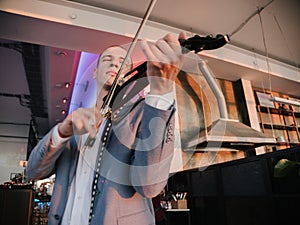 Violinist engages with electric violin, passion in his expression