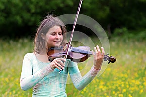 Violinist on a meadow full of flowers