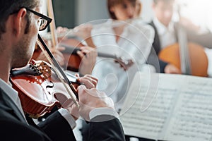 Violinist performing with classical orchestra