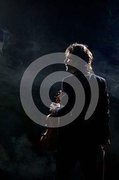 Violinist a player with a violin instrument in his hands. Artist of classical music or alternative music direction. Concept of