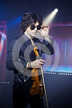 Violinist a player with a violin instrument in his hands. Artist of classical music or alternative music direction. Concept of