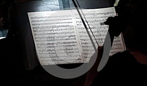 violinist reading scales in the dark