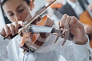 Violinist tuning a violin