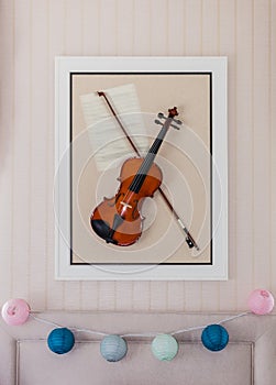 Violon with fiddlestick decoration on wall photo