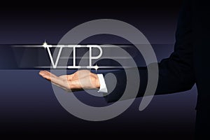 VIP member. Closeup view of man showing virtual abbreviation on dark background