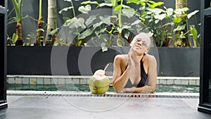 VIP vacation tropical tour with luxury resort, pool area. Woman drinks coconut