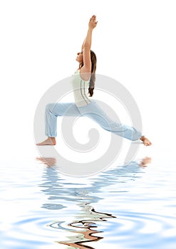 Virabhadrasana warrior pose on white sand #2