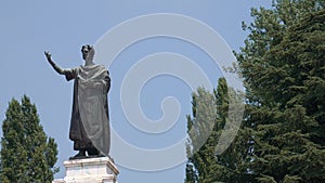 Virgil statue, figure on the left, copy space on the right, Mantua