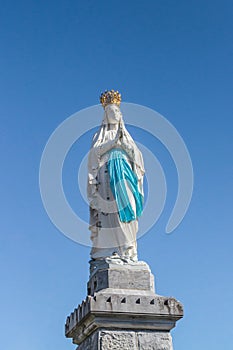 Virgin of Lourdes against the sky