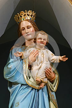 Virgin Mary with baby Jesus, statue on the main altar in the church of the Holy Trinity in Donja Stubica, Croatia photo