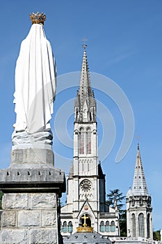 Virgin Mary and basilica in pilgrim town Lourdes