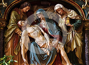Virgin Mary cradling the dead body of Jesus photo