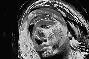 Virgin Mary. Fragment of amcient statue of sad woman in grief photo