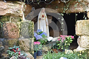 Virgin mary statue in a stone niche