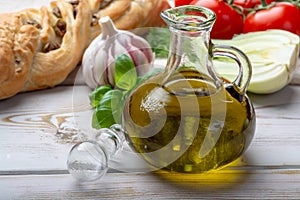 Virgin natural olive oil is glass bottle, served with traditional Mediterranean food photo