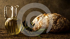 Virgin olive oil in vintage oil jar and rustic bread