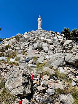 Virgin statue Notre Dame de Neige at Col de Bavella, Corsica, France. Vertical.