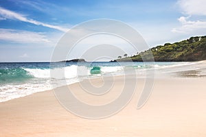Virgin white sand beach Bali with turquoise sea water big waves blue sky