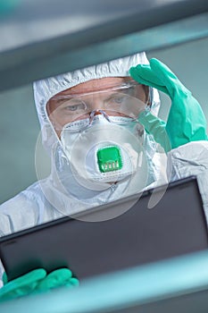 Virologist healthcare professional using tablet computer in laboratory