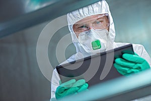 Virologist healthcare professional using tablet computer in laboratory