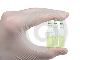 Virologist holds three ampoules of a new vaccine from Covid-19 in his hand isolated