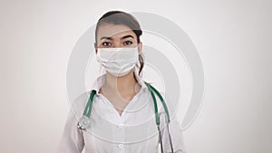 A virologist in a medical mask holding a syringe with a vaccine