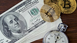 Virtual currency Bitcoin BTC with stack of 100 USD denomination note and metal stopwatch
