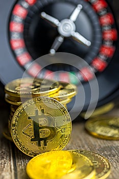 Virtual money Bitcoin BTC cryptocurrency - risky invenstment with the Bitcoins currency - gold coin with a roulette as a symbol of