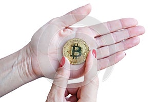 Virtual money golden bitcoin women hand with red nails fingers isolated on white background