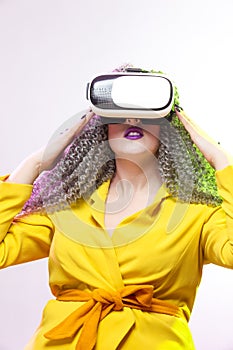 Virtual Reality Concepts. Portrait of caucasian Girl With Curly Colorful Hair Playing With VR Virtual Reality Helmet