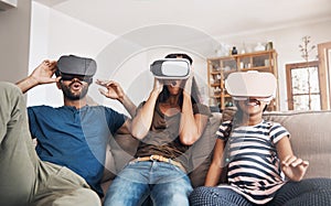 Virtual reality fun for all ages. a young family using virtual reality headsets together at home.