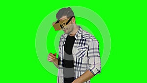 Virtual reality game. Boy uses head mounted display. Green screen