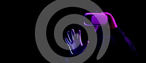 Virtual reality game vr. Young man in digital glasses for virtual reality technology  on dark neon background