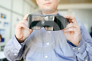 Virtual reality headset closeup in man's hands.