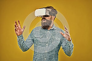 Virtual reality is truly here. Bearded man wear virtual reality headset. Hipster explore virtual reality yellow