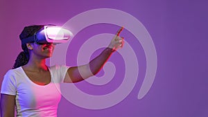 Virtual World. Portrait Of Excited Black Female Wearing VR Headset Touching Air