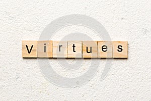 virtues word written on wood block. virtues text on cement table for your desing, concept