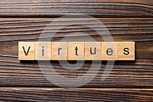 Virtues word written on wood block. virtues text on wooden table for your desing, concept