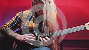 A virtuoso guitarist playing an electric guitar with LED lights