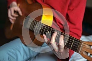 Virtuoso guitarist playing his acoustic guitar photo