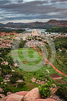 Virupaksha temple with bright dramatic sky and rocky mountain background at morning