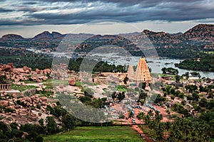 Virupaksha temple with bright dramatic sky and rocky mountain background at morning from hill top