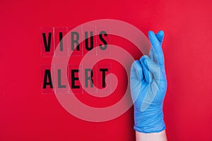 VIRUS ALERT on a red background and a gloved hand.