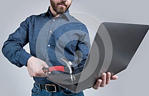 Virus attack. Man cropped view hit laptop with hammer. Virus threat. Virus-killing software photo