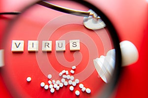 Virus COVID-19 concept image wit text seen through a magnifying glass. Red background