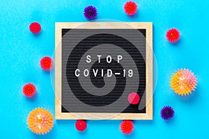 Virus COVID-19 protection concept. Virus abstract models with letterboard Stop COVID-19 on blue background